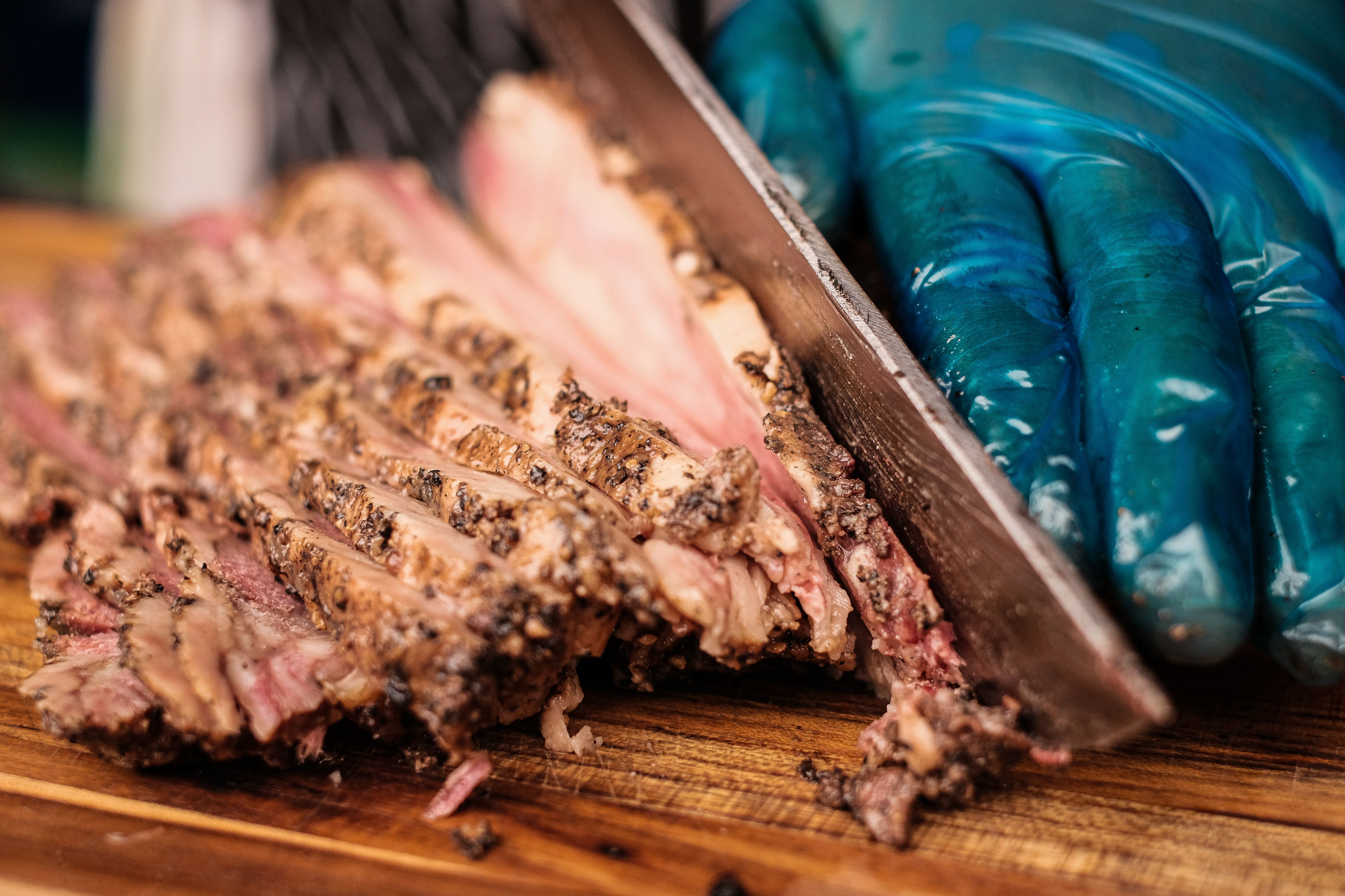 Generic barbecue brisket being sliced on a cutting board